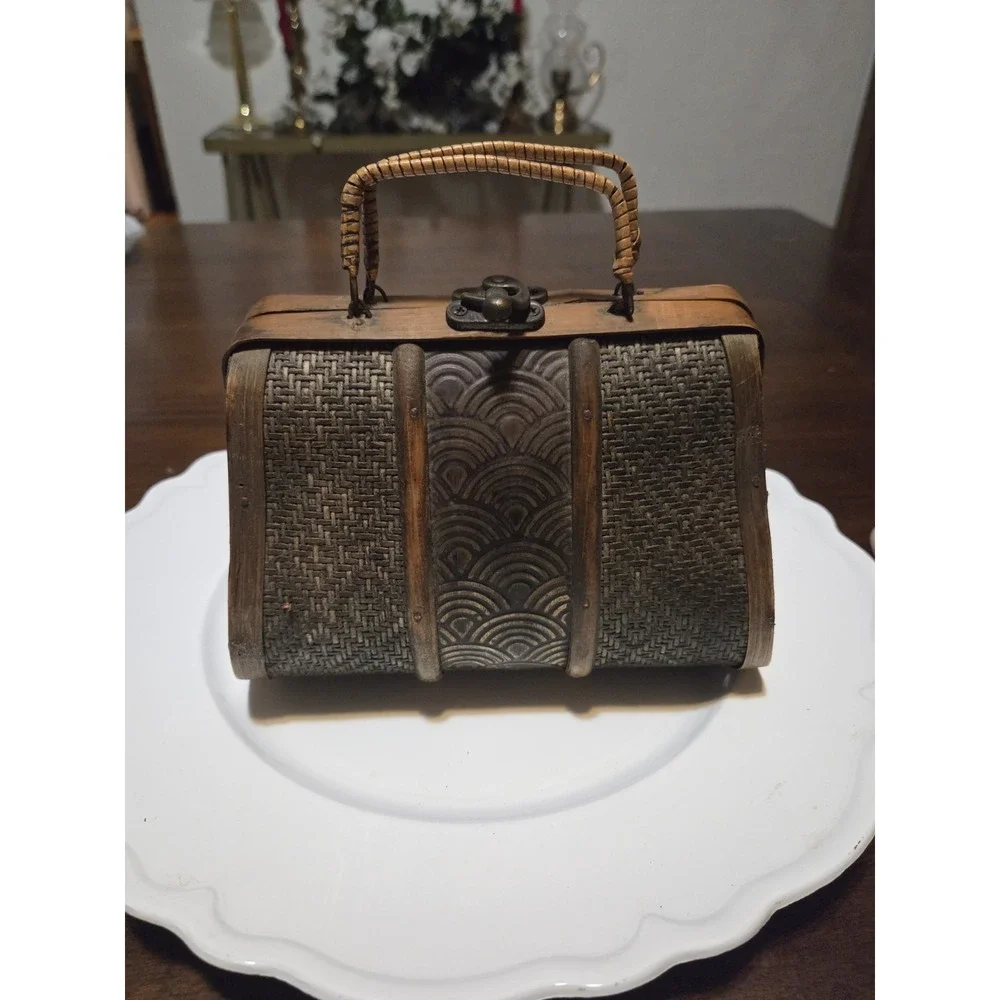 vintage-style handbag features a dark wood and woven bamboo body